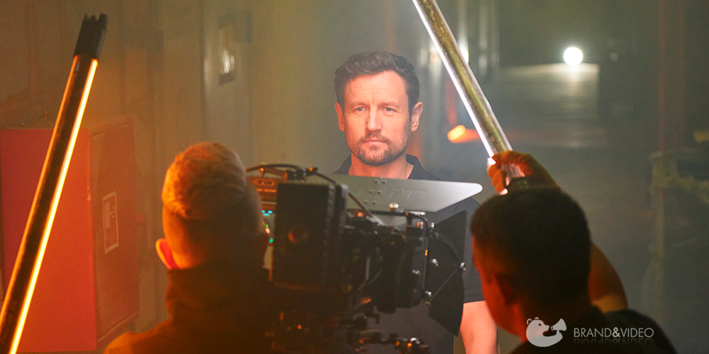 Оператор снимает мужчину, дым и цветные лампы