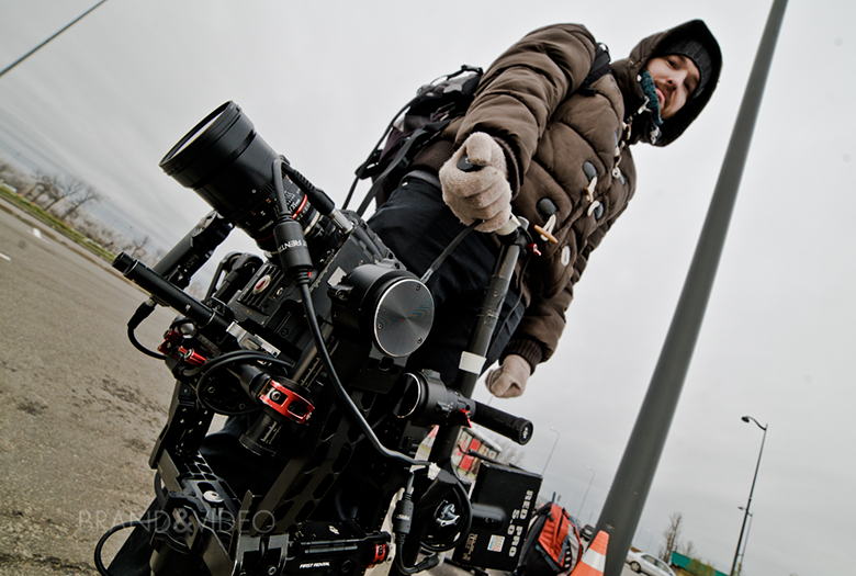 Видеооператор в перчатках с камерой RED